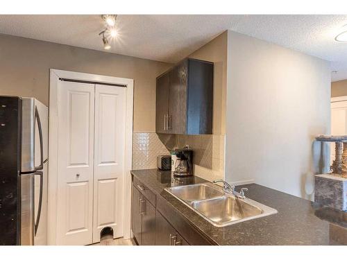 3205-403 Mackenzie Way Sw, Airdrie, AB - Indoor Photo Showing Kitchen With Double Sink