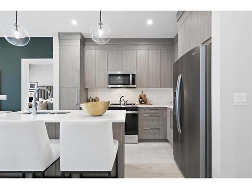 3106-111 Wolf Creek Drive Se, Calgary, AB - Indoor Photo Showing Kitchen With Stainless Steel Kitchen With Upgraded Kitchen