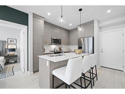 3106-111 Wolf Creek Drive Se, Calgary, AB - Indoor Photo Showing Kitchen With Stainless Steel Kitchen With Double Sink With Upgraded Kitchen