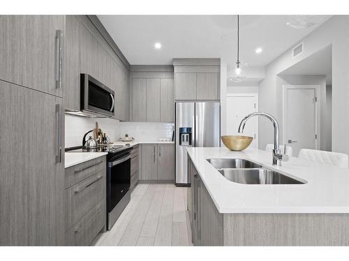 3106-111 Wolf Creek Drive Se, Calgary, AB - Indoor Photo Showing Kitchen With Stainless Steel Kitchen With Double Sink With Upgraded Kitchen