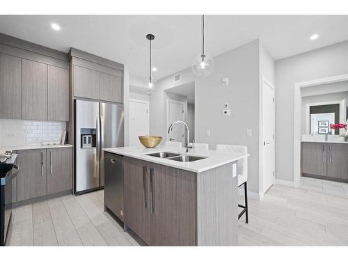 3106-111 Wolf Creek Drive Se, Calgary, AB - Indoor Photo Showing Kitchen With Stainless Steel Kitchen With Double Sink With Upgraded Kitchen