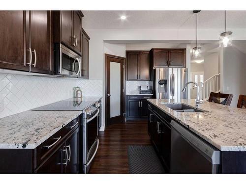 616 Reynolds Crescent Sw, Airdrie, AB - Indoor Photo Showing Kitchen With Double Sink With Upgraded Kitchen