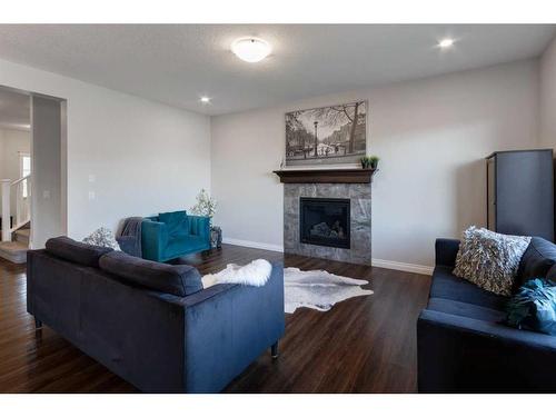 616 Reynolds Crescent Sw, Airdrie, AB - Indoor Photo Showing Living Room With Fireplace