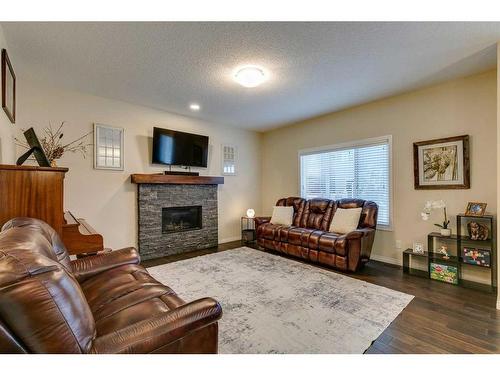 26 Mount Rae Terrace, Okotoks, AB - Indoor Photo Showing Living Room With Fireplace