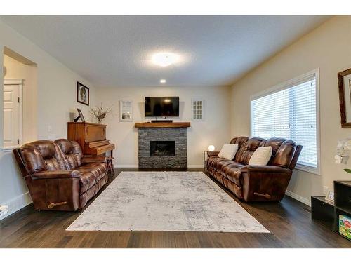 26 Mount Rae Terrace, Okotoks, AB - Indoor Photo Showing Living Room With Fireplace