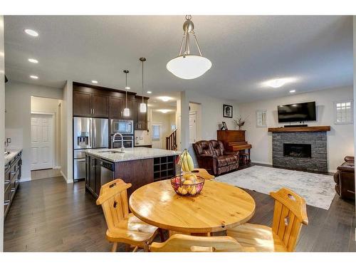 26 Mount Rae Terrace, Okotoks, AB - Indoor Photo Showing Dining Room With Fireplace