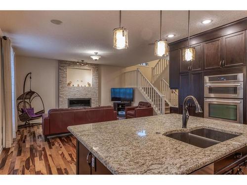 14 Aspen Acres Link Sw, Calgary, AB - Indoor Photo Showing Kitchen With Fireplace With Double Sink With Upgraded Kitchen