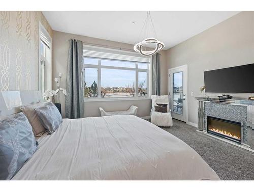 101-17 Mahogany Circle Se, Calgary, AB - Indoor Photo Showing Bedroom With Fireplace