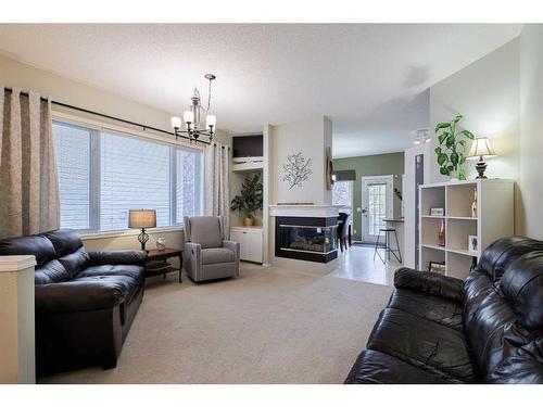 113 Tuscany Way Nw, Calgary, AB - Indoor Photo Showing Living Room With Fireplace