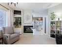 113 Tuscany Way Nw, Calgary, AB  - Indoor Photo Showing Living Room With Fireplace 