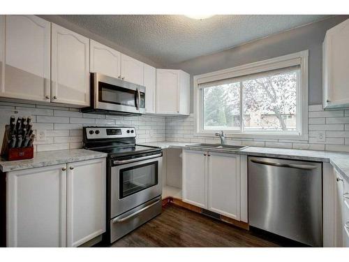 9-7 Westland Road, Okotoks, AB - Indoor Photo Showing Kitchen With Stainless Steel Kitchen With Upgraded Kitchen