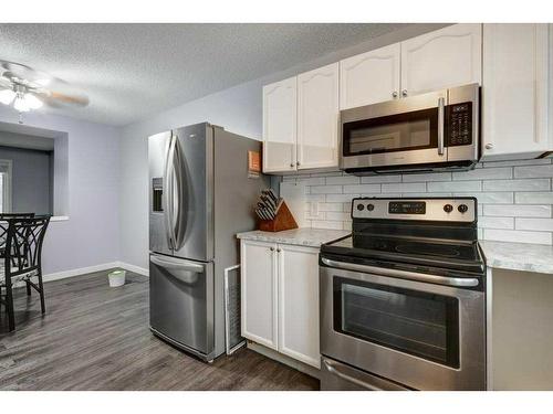 9-7 Westland Road, Okotoks, AB - Indoor Photo Showing Kitchen With Stainless Steel Kitchen