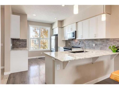 260 Midyard Lane Sw, Airdrie, AB - Indoor Photo Showing Kitchen With Upgraded Kitchen