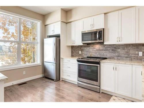 260 Midyard Lane Sw, Airdrie, AB - Indoor Photo Showing Kitchen With Upgraded Kitchen