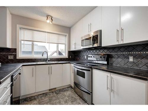 5 Prestwick Mount Se, Calgary, AB - Indoor Photo Showing Kitchen With Double Sink