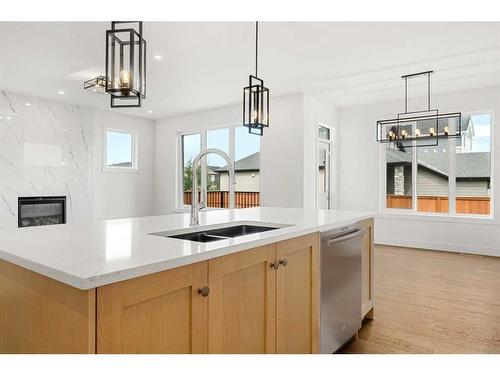 319 Legacy Mount Se, Calgary, AB - Indoor Photo Showing Kitchen With Fireplace With Double Sink