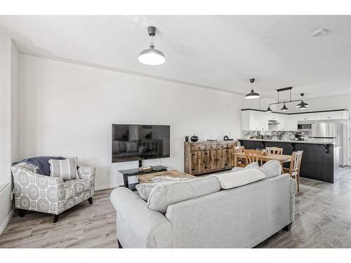 703-2001 Luxstone Boulevard Sw, Airdrie, AB - Indoor Photo Showing Living Room