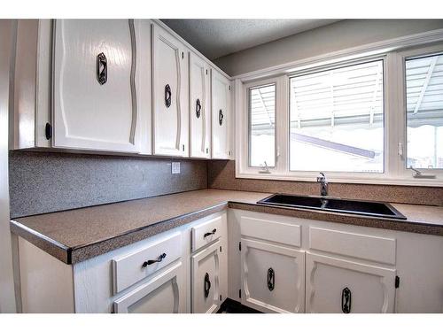 135 Pensville Road Se, Calgary, AB - Indoor Photo Showing Kitchen With Double Sink