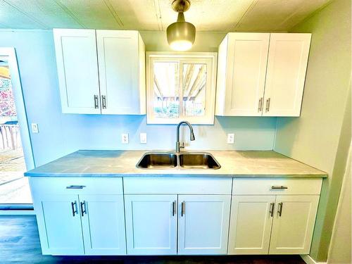 1921 21 Street, Nanton, AB - Indoor Photo Showing Kitchen With Double Sink