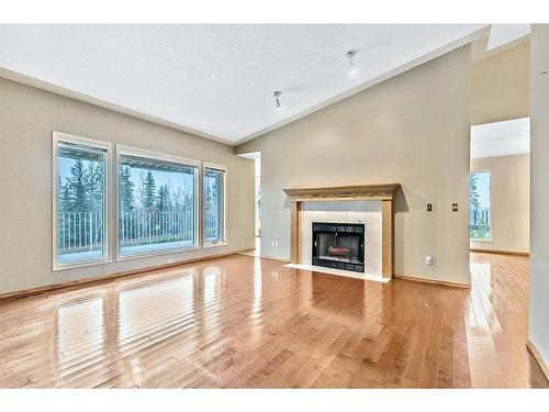 125 Shawnee Place Sw, Calgary, AB - Indoor Photo Showing Living Room With Fireplace