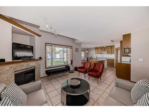 26 Arbour Butte Road Nw, Calgary, AB - Indoor Photo Showing Living Room With Fireplace