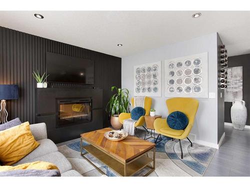 106-800 Yankee Valley Boulevard Se, Airdrie, AB - Indoor Photo Showing Living Room With Fireplace