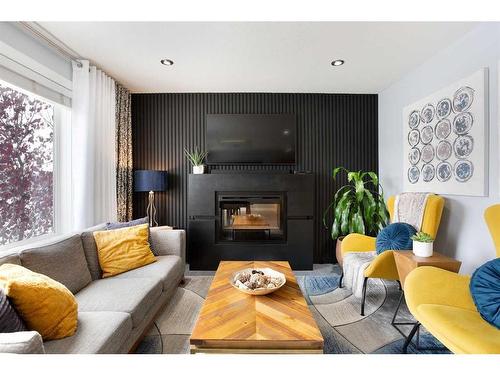 106-800 Yankee Valley Boulevard Se, Airdrie, AB - Indoor Photo Showing Living Room With Fireplace