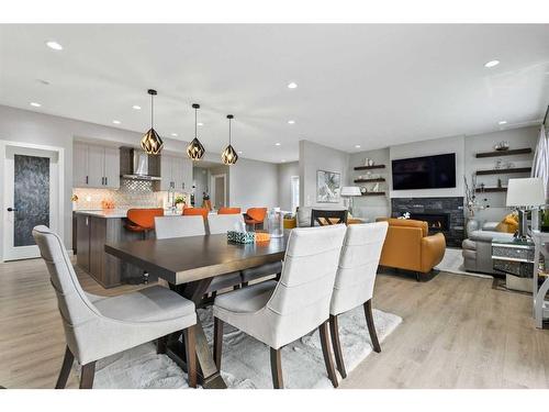 56 Legacy Bay Se, Calgary, AB - Indoor Photo Showing Dining Room With Fireplace