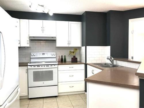 2318-60 Panatella Street Nw, Calgary, AB - Indoor Photo Showing Kitchen With Double Sink