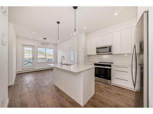 3405-111 Wolf Creek Drive Se, Calgary, AB - Indoor Photo Showing Kitchen With Stainless Steel Kitchen With Double Sink With Upgraded Kitchen