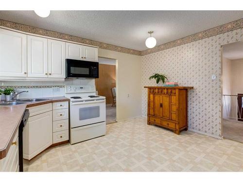 16 Capri Avenue Nw, Calgary, AB - Indoor Photo Showing Kitchen With Double Sink