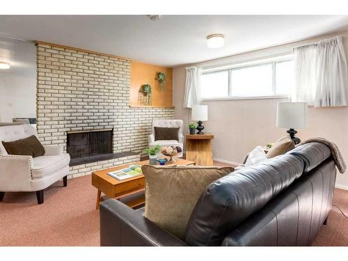 16 Capri Avenue Nw, Calgary, AB - Indoor Photo Showing Living Room With Fireplace