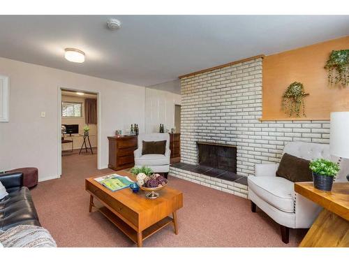 16 Capri Avenue Nw, Calgary, AB - Indoor Photo Showing Living Room With Fireplace