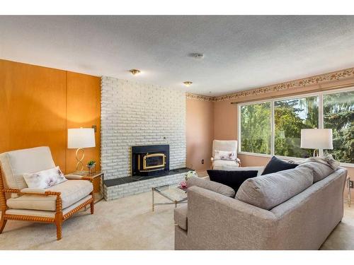 16 Capri Avenue Nw, Calgary, AB - Indoor Photo Showing Living Room With Fireplace