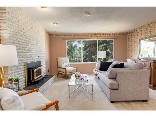 16 Capri Avenue Nw, Calgary, AB - Indoor Photo Showing Living Room With Fireplace