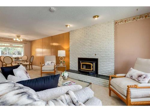 16 Capri Avenue Nw, Calgary, AB - Indoor Photo Showing Living Room With Fireplace