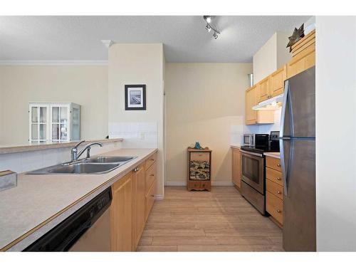 1310-1010 Arbour Lake Road Nw, Calgary, AB - Indoor Photo Showing Kitchen With Double Sink