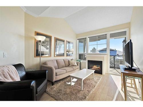 1310-1010 Arbour Lake Road Nw, Calgary, AB - Indoor Photo Showing Living Room With Fireplace