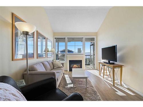 1310-1010 Arbour Lake Road Nw, Calgary, AB - Indoor Photo Showing Living Room With Fireplace