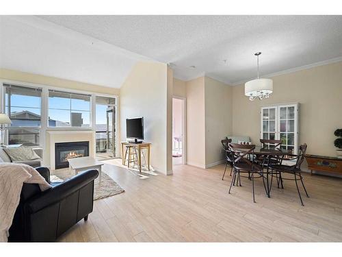 1310-1010 Arbour Lake Road Nw, Calgary, AB - Indoor With Fireplace