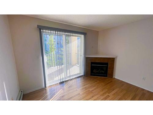 3307-4975 130 Avenue Se, Calgary, AB - Indoor Photo Showing Living Room With Fireplace