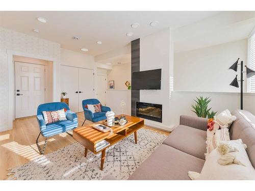 911-10060 46 Street Ne, Calgary, AB - Indoor Photo Showing Living Room With Fireplace