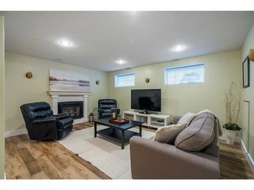 1131 Lake Bonavista Drive Se, Calgary, AB - Indoor Photo Showing Basement With Fireplace