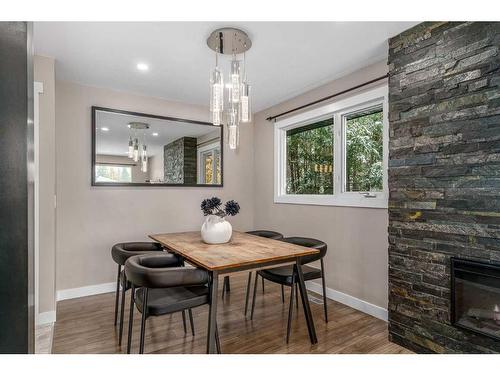 363 Acadia Drive Se, Calgary, AB - Indoor Photo Showing Dining Room With Fireplace