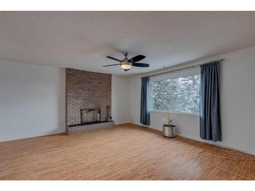 106 Huntham Place Ne, Calgary, AB - Indoor Photo Showing Other Room With Fireplace