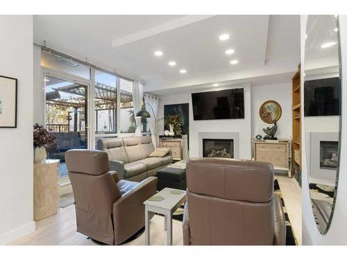 231-222 Riverfront Avenue Sw, Calgary, AB - Indoor Photo Showing Living Room With Fireplace