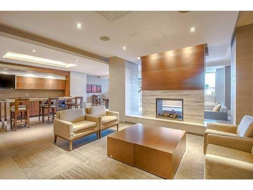 231-222 Riverfront Avenue Sw, Calgary, AB - Indoor Photo Showing Living Room With Fireplace