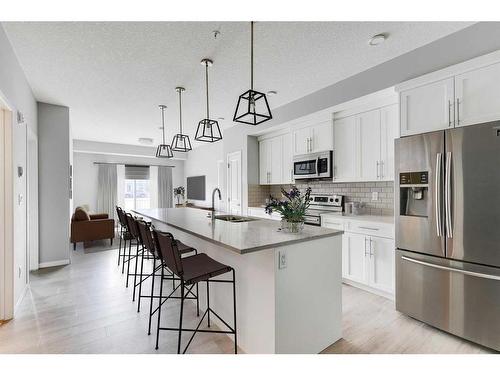 102-4150 Seton Drive Se, Calgary, AB - Indoor Photo Showing Kitchen With Stainless Steel Kitchen With Upgraded Kitchen