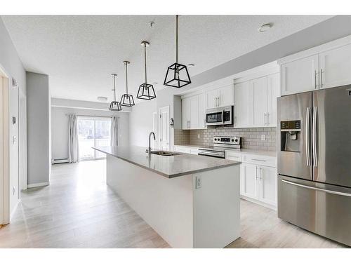 102-4150 Seton Drive Se, Calgary, AB - Indoor Photo Showing Kitchen With Stainless Steel Kitchen With Upgraded Kitchen