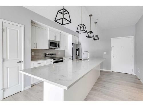 102-4150 Seton Drive Se, Calgary, AB - Indoor Photo Showing Kitchen With Upgraded Kitchen